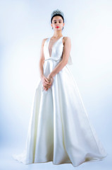 Fototapeta premium beautiful bride posing in white dress with wedding, isolated on a light background