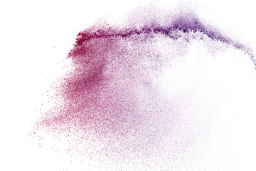 Freeze motion of purple color powder exploding on white background.