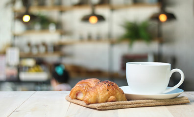 Croissant and coffee   on wood table