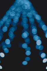 Beautiful and different bokeh lights of the night city in classic blue color.