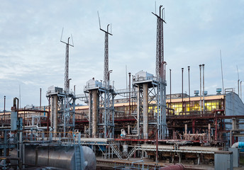 At modern chemical plant. Air cooling system with electric motors and synthesis columns of chemical...
