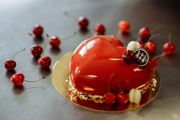 delicious red cake with cherry in the form of heart