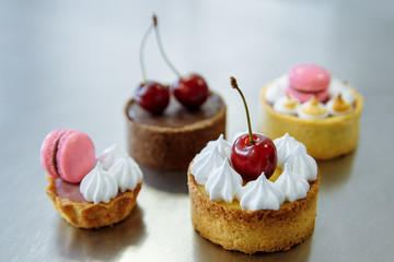 four delicious cherry cakes and macaron