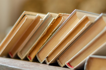 Bookshelf with old books. Shelf in a bookstore with books for donation or free exchange. Close-up...