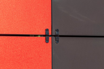 Red and Black ceramic composite panel wall. Fragment of a ventilated facade