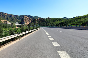 Empty highway, blue sky and white clouds landscape