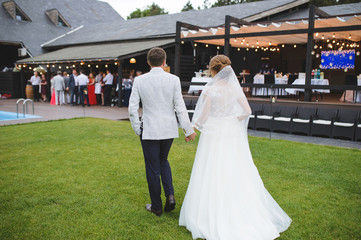 Fototapeta na wymiar bride and groom walking to guests