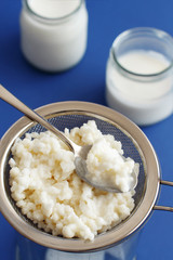 Fermented drink kefir in small bottles and kefir grains