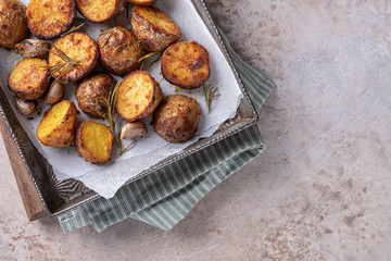 Roasted potato with rosemary on a baking sheet