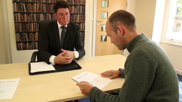 Man Signing Divorce Papers in Solicitor's / Lawyer's office - Stock Video Clip Footage 