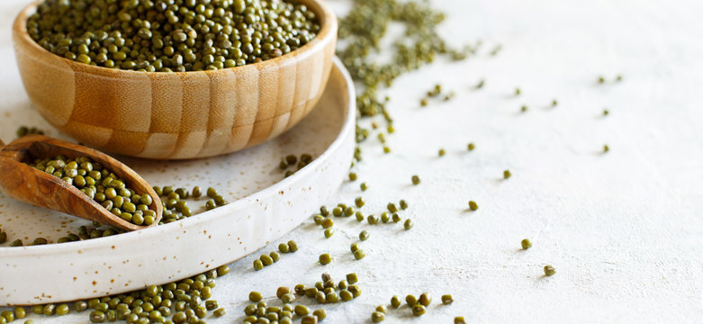 Dried mung beans in wooden bowl with a spoon