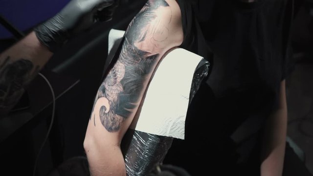 Video of doing black tattoo for woman in studio