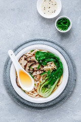 Asian Vegetarian Udon or Ramen noodles soup in bowl with Shiitake mushrooms and Bok Choy