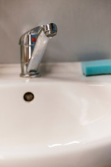 Water drop on the tap at the sink.