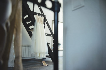 lace wedding dress and shoes at black stairs