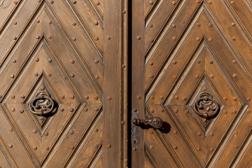 An old wooden door with a rusty lock