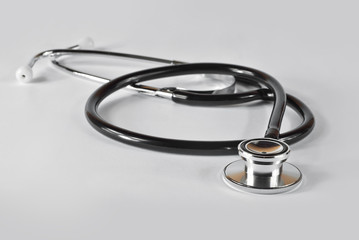 Stethoscope on a white background. Medical equipment on the table.