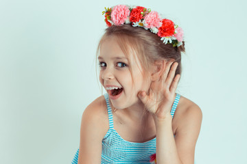 Happy kid girl hand to ear eavesdropping trying to hear to a chipchat
