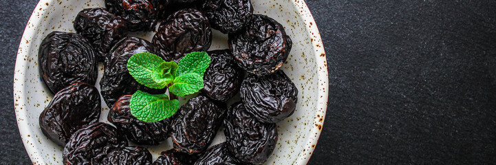 prunes, dried plums (tasty and healthy fruits) menu concept. background. top view. copy space