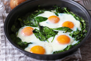 Selective focus. Fried eggs with spinach. Glorious food. Keto diet.