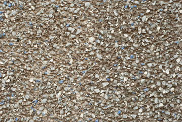 The texture of the wall is made of small blue and white stones.