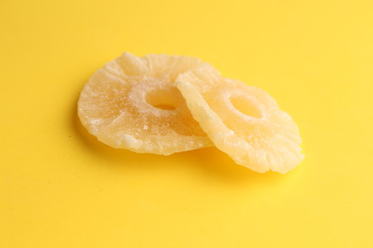 piece of dried pineapple fruit in color background