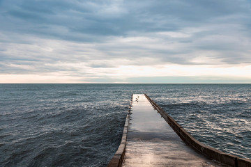Obraz premium Stone pier. Concrete pier. Sea in winter. Black Sea.
