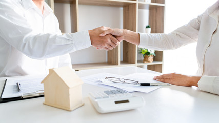 House developers and customer shaking hand after finish buying or rental real estate for transfer...