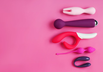 Silicone sex toys on a pink background. Erotic toy for fun. Sex gadget and masturbation device..