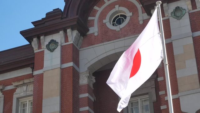 Japan flag with background of modern high-rise building in Tokyo,Japan