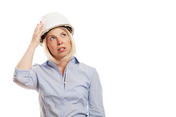 Young woman in a blue shirt and white construction helmet. Isolated over white background. Close-up.
