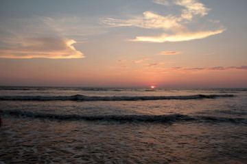 sunrise on the Indian ocean coast. morning seascape with sun and clouds