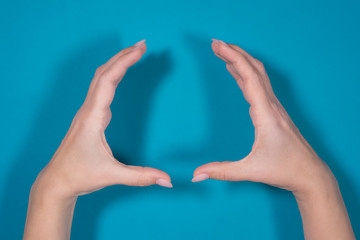 Closeup top view photo of two female hands making circle gesture with rounded two palms as if...