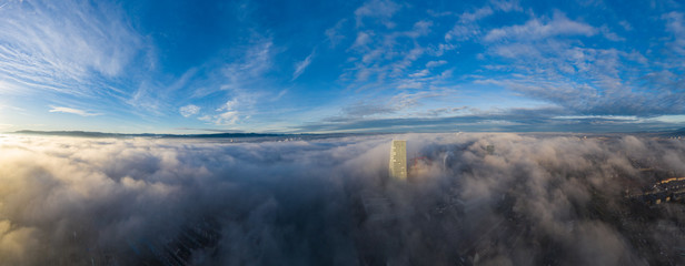 Sea of fog over the Basel city, Switzerland at sunrise shot from a drone
