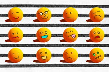 Concept of different emotions with cartoons face like sad angry happy smile illustrated on ping pong ball and black striped and white texture background.