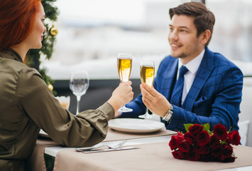 saint valentines day, 8 march, birthday, celebration concept. young and beautiful caucasian lady and handsome guy having dinner,celebrating their anniversary in restaurant. emotions, love