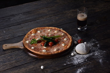 fresh pizza with tomatoes on the table