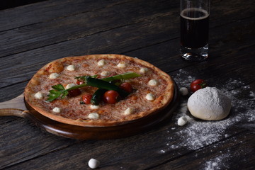 fresh pizza with tomatoes on the table