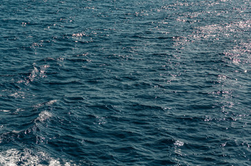 Background shot of aqua sea water surface. Abstract texture of nature. Rapid sea while sailing ship