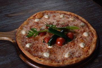 fresh pizza with tomatoes on the table