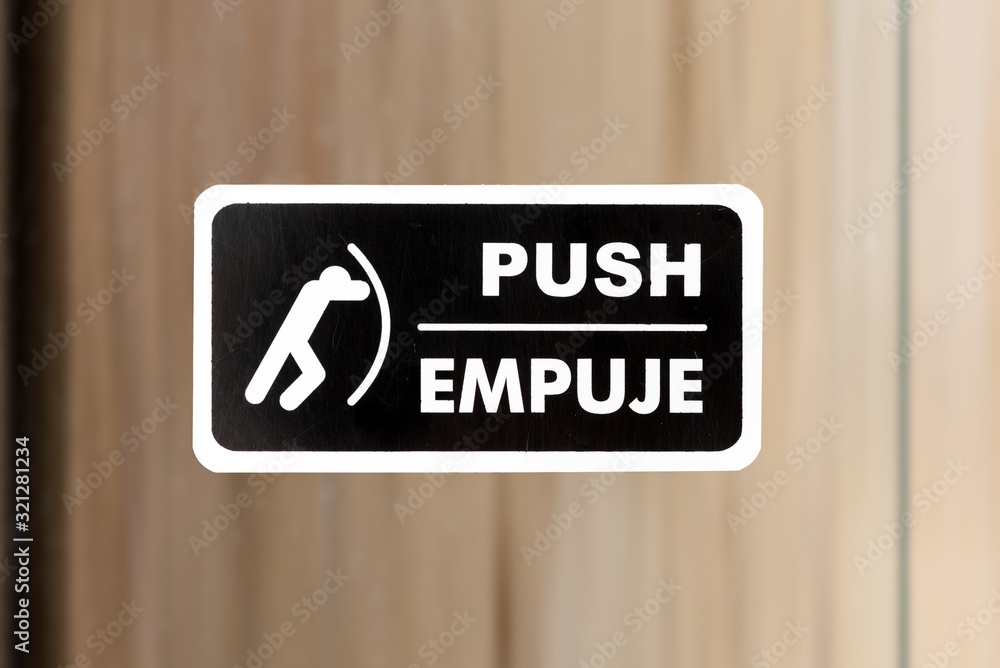 Wall mural push sign on glass door at the office