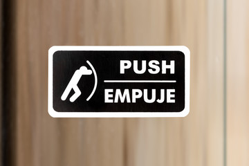 PUSH sign on glass door at the office