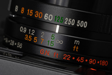 Shutter speed and focus distance values on a vintage film camera