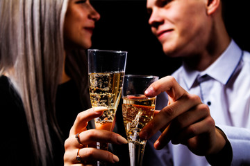 Close-up portrait of a loving couple greeting each other happy lovers day with glasses of champagne. Valentine's Day.