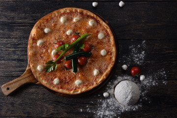 fresh pizza with tomatoes on the table