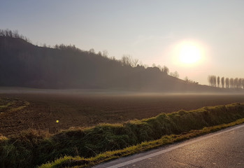 Hill profile at sunset with light mist
