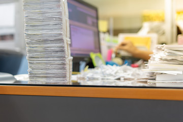 Stack of documents on desktop in office.