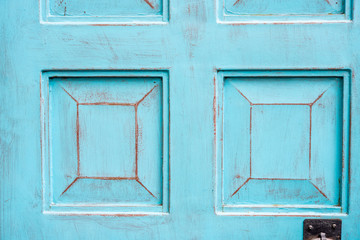 Close up background detail of vintage and rustic blue cyan wood door, with space for text