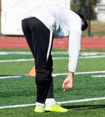 Obraz premium Male athlete pre game stretching