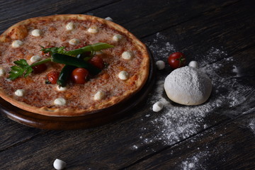 fresh pizza with tomatoes on the table